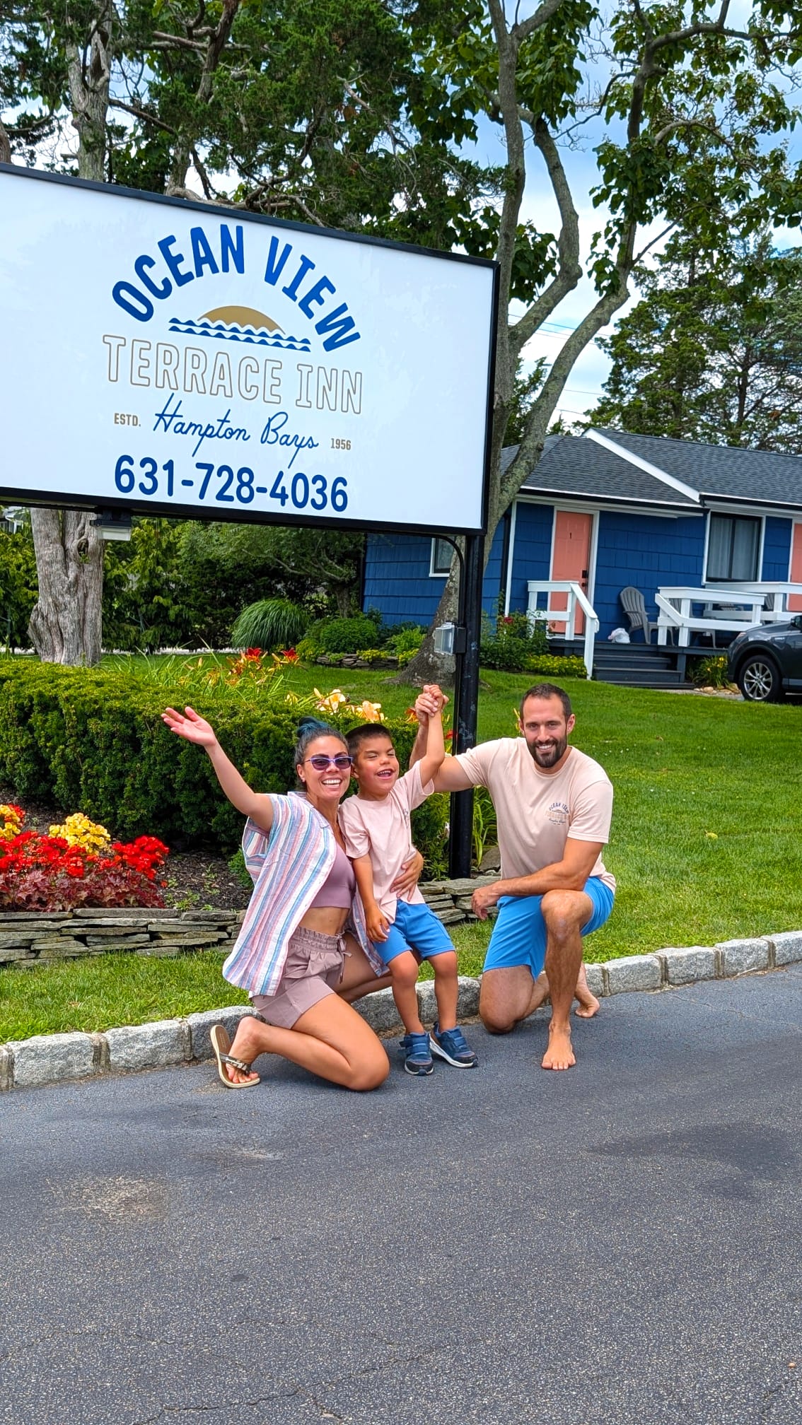 Yanni, Adrianna, and family in front of the Ocean View Terrace Inn sign