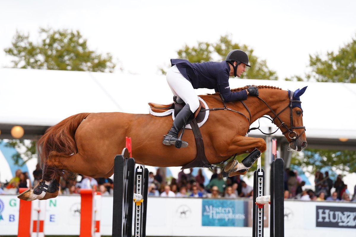 Equestrian rider clearing a jump at the Hampton Classic Horse Show
