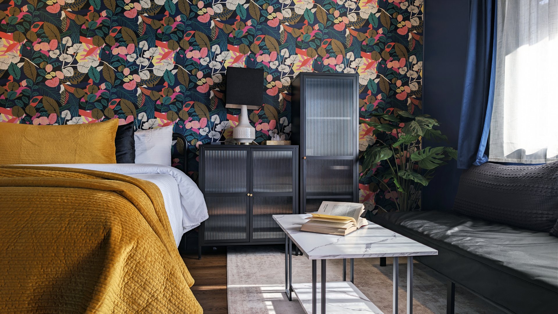 Indigo Studio King at Ocean View Terrace Inn with bold botanical wallpaper, mustard quilt, and dark blue accents